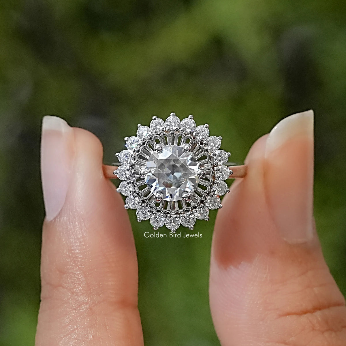Sterling silver halo ring with a round center stone and flower-shaped cluster of clear stones.