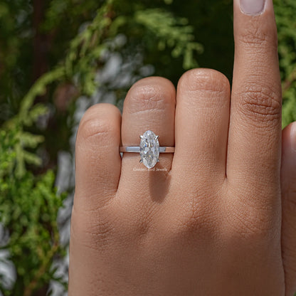 Oval-cut moissanite solitaire ring on finger, slim band with four prongs