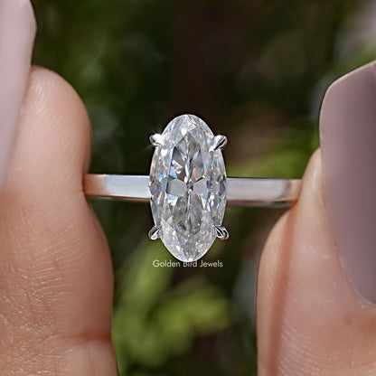 Oval moissanite solitaire ring with four-prong setting and slim band