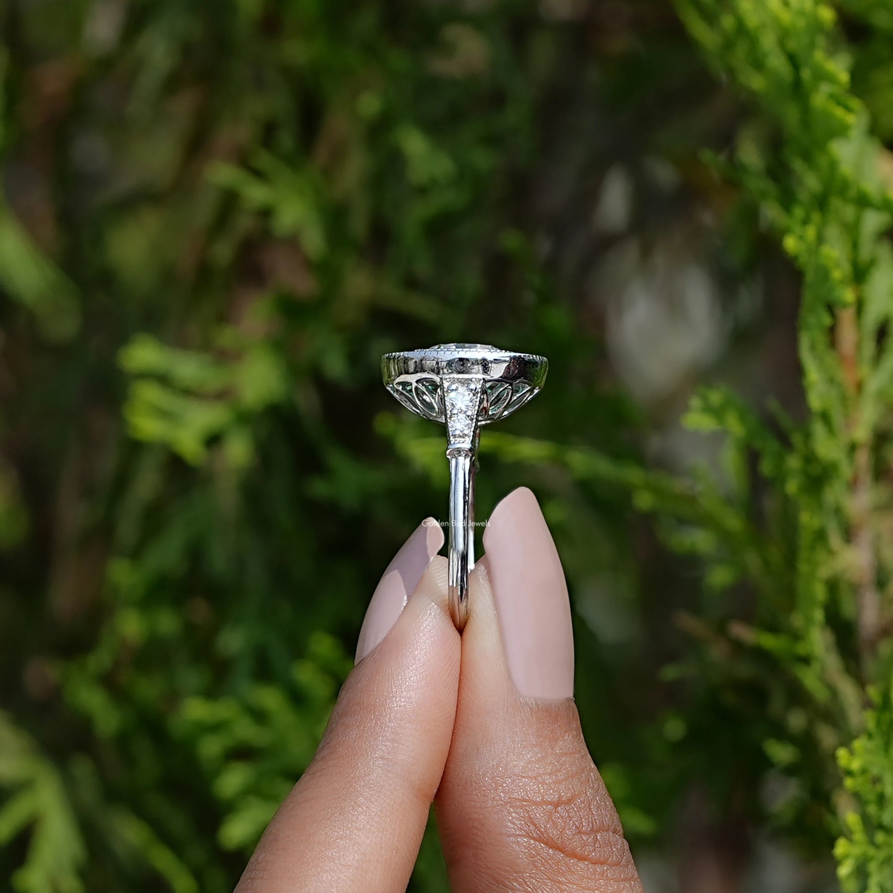 Side View of Round Cut Moissanite Engagement Ring In two fingers