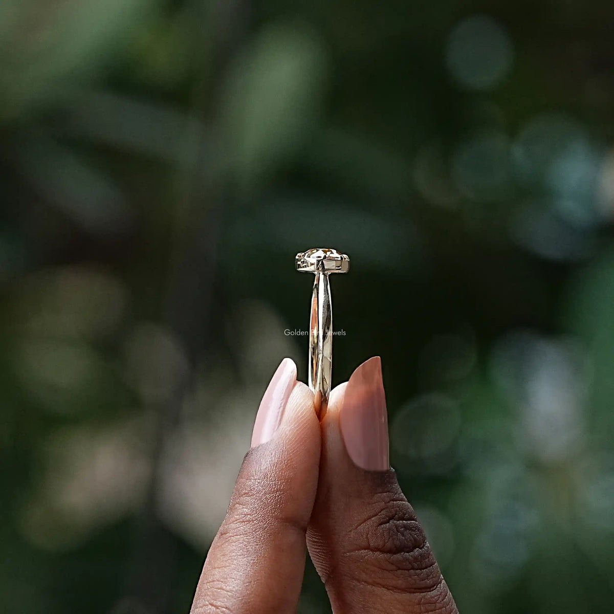 Side View of Round Cut Moissanite Solitaire Ring In two fingers