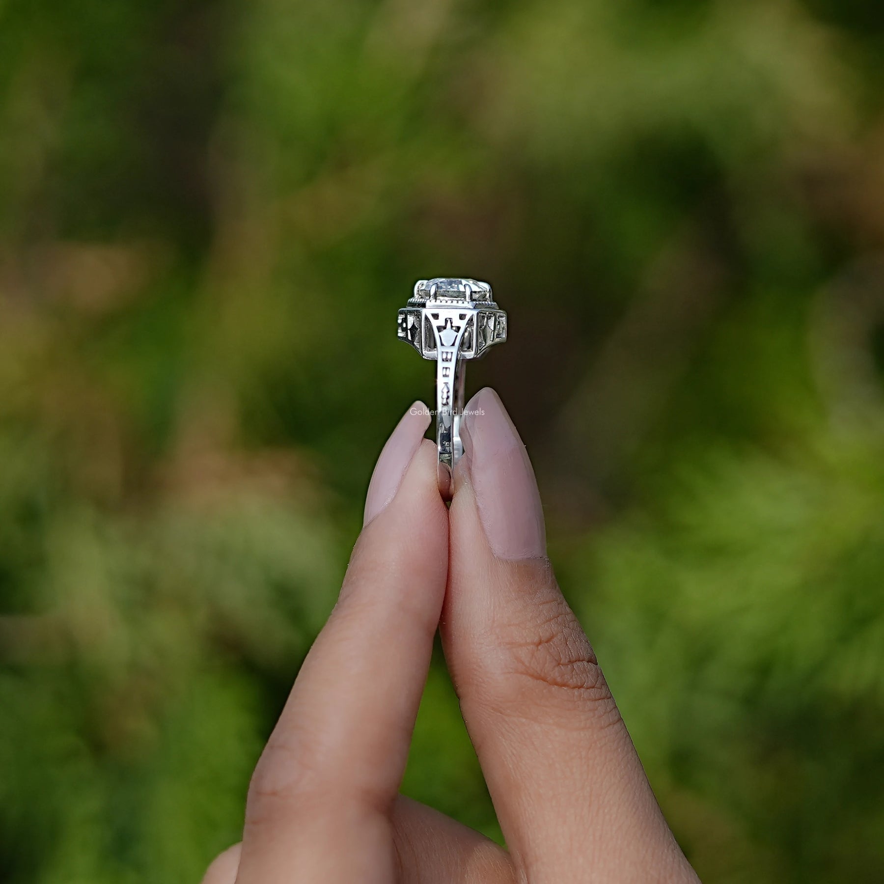 Side View of Round Cut Moissanite Solitaire Ring In two fingers