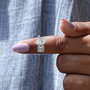 In finger front View of Cushion And Old Mine Pear Cut Moissanite Ring In White Gold