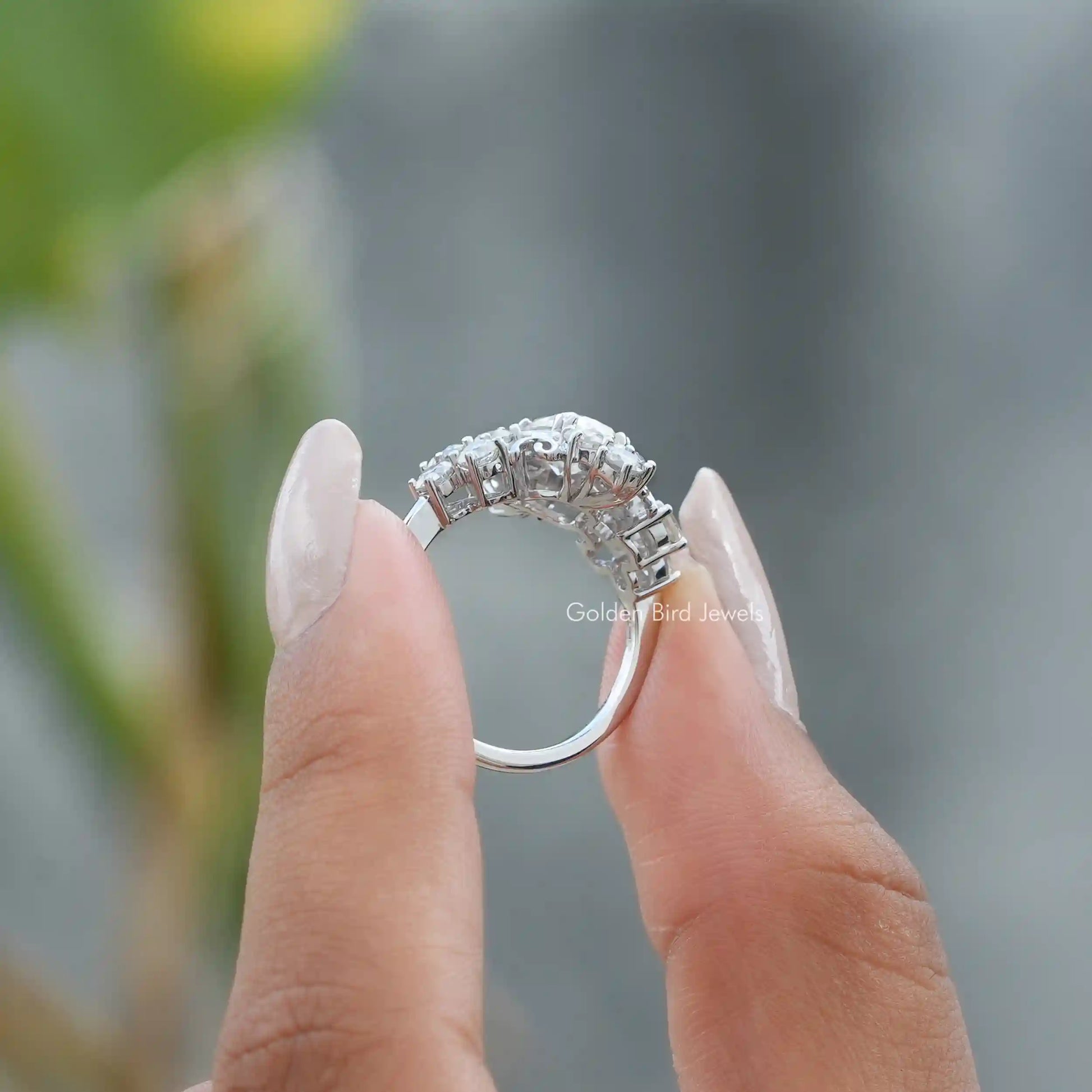 Back View of Cushion Cut Moissanite Vintage Style Engagement Ring In two fingers