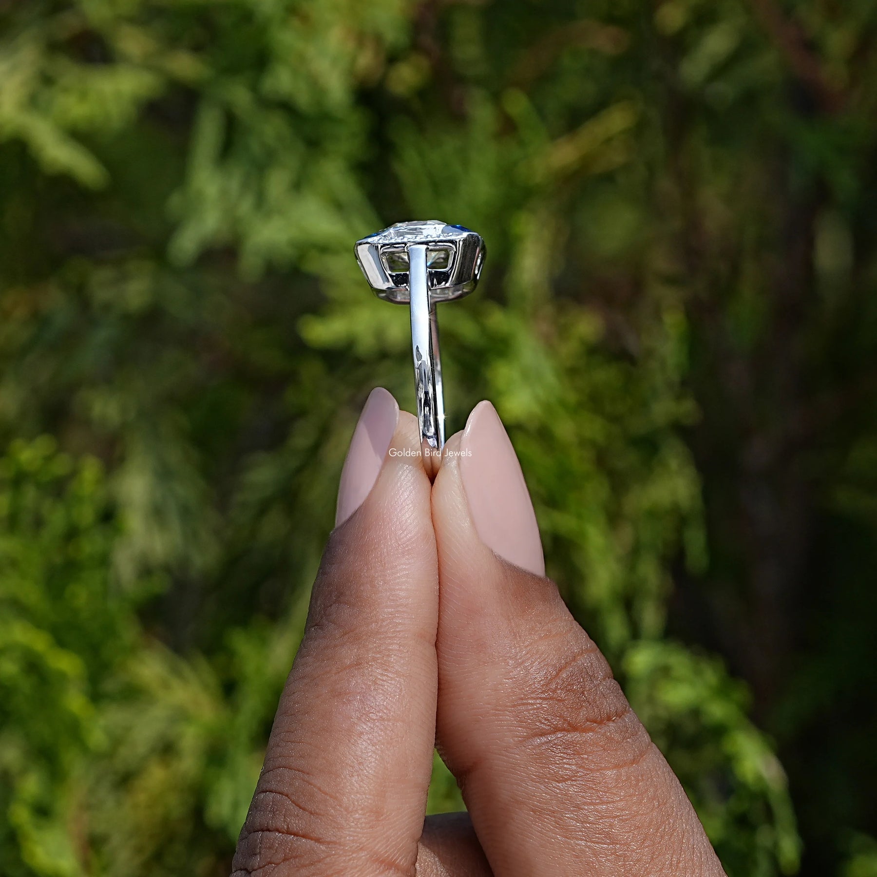 Side View of Old Mine Cushion Moissanite Engagement Ring In two fingers