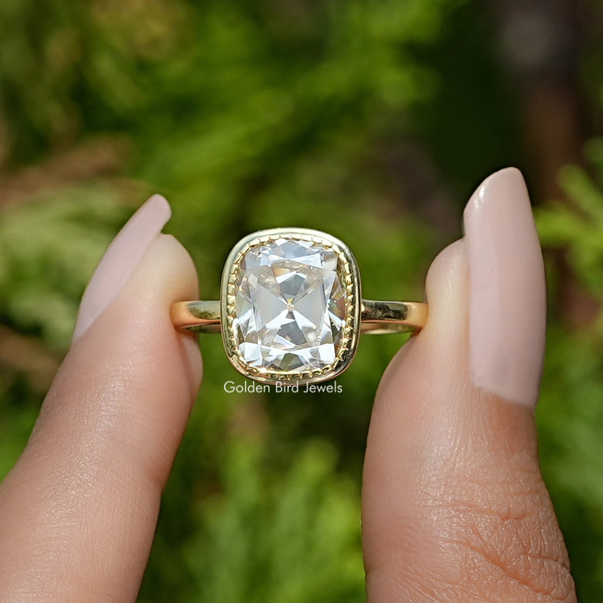 Front View of Old Mine Cushion Cut Moissanite Solitaire Ring In two Fingers