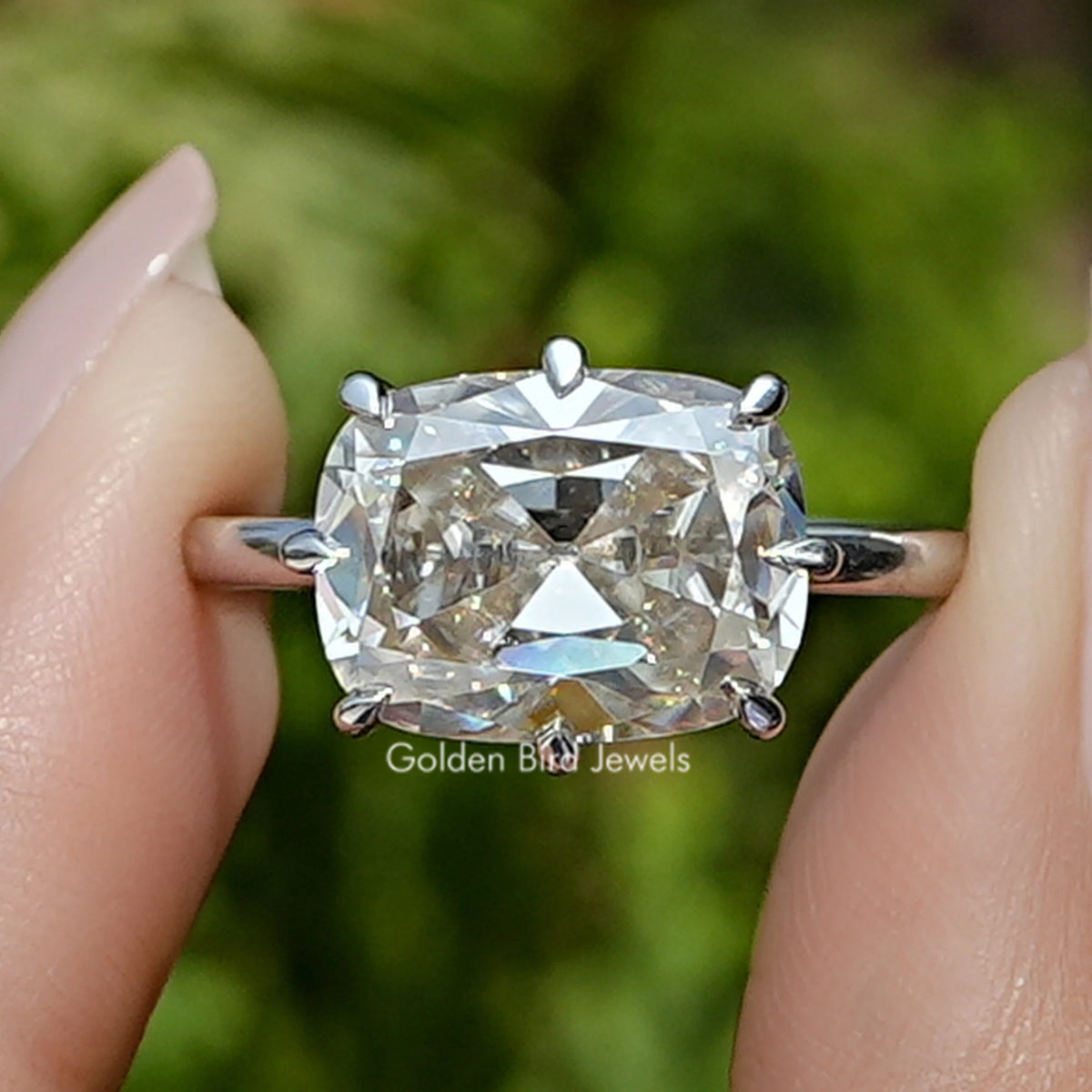 Front view of Old Mine Cushion Cut Moissanite Ring in two fingers 