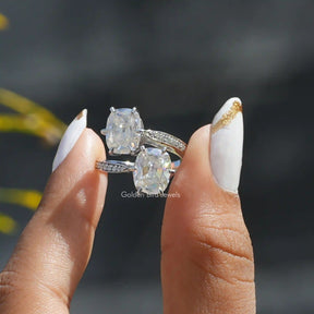 Two fingers holding the Old Mine Cushion Cut Moissanite Ring