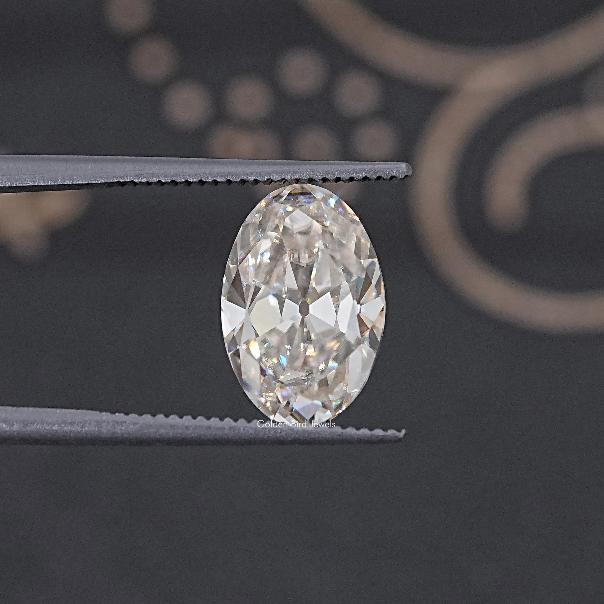 In Tweezer View Of Old Mine Oval Cut Loose Moissanite Stone