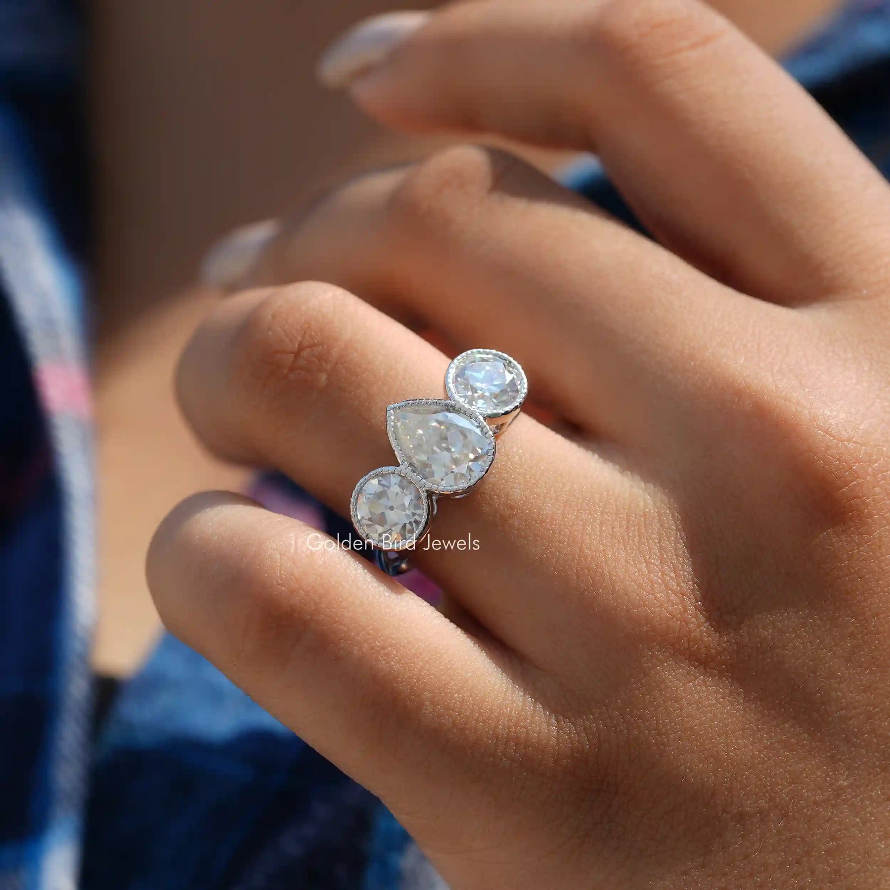 View of Old Mine Pear And Round Cut Moissanite Ring In Finger