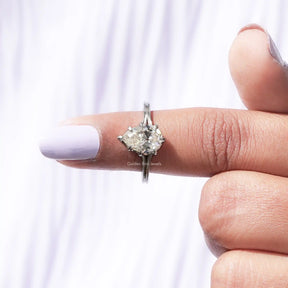 In finger front view of pear  shape moissanite wedding ring in  unique pattern