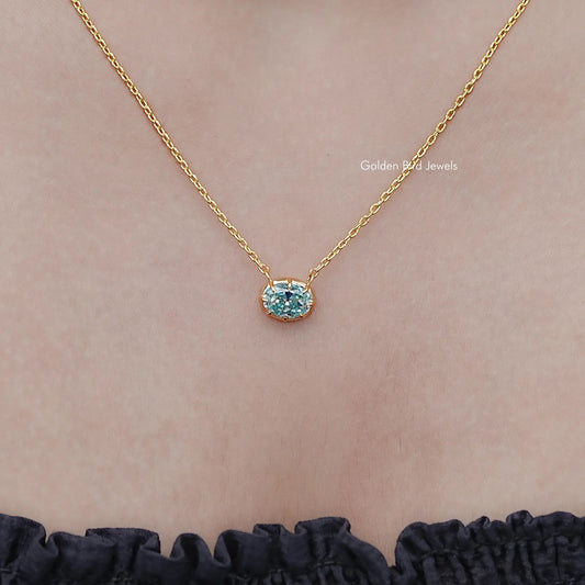 Oval light-blue gemstone solitaire pendant on gold-tone necklace