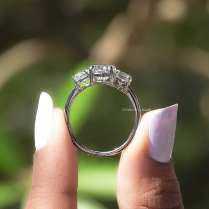 Back View of Moissanite Oval And Half Moon 3 Stone Ring In two fingers