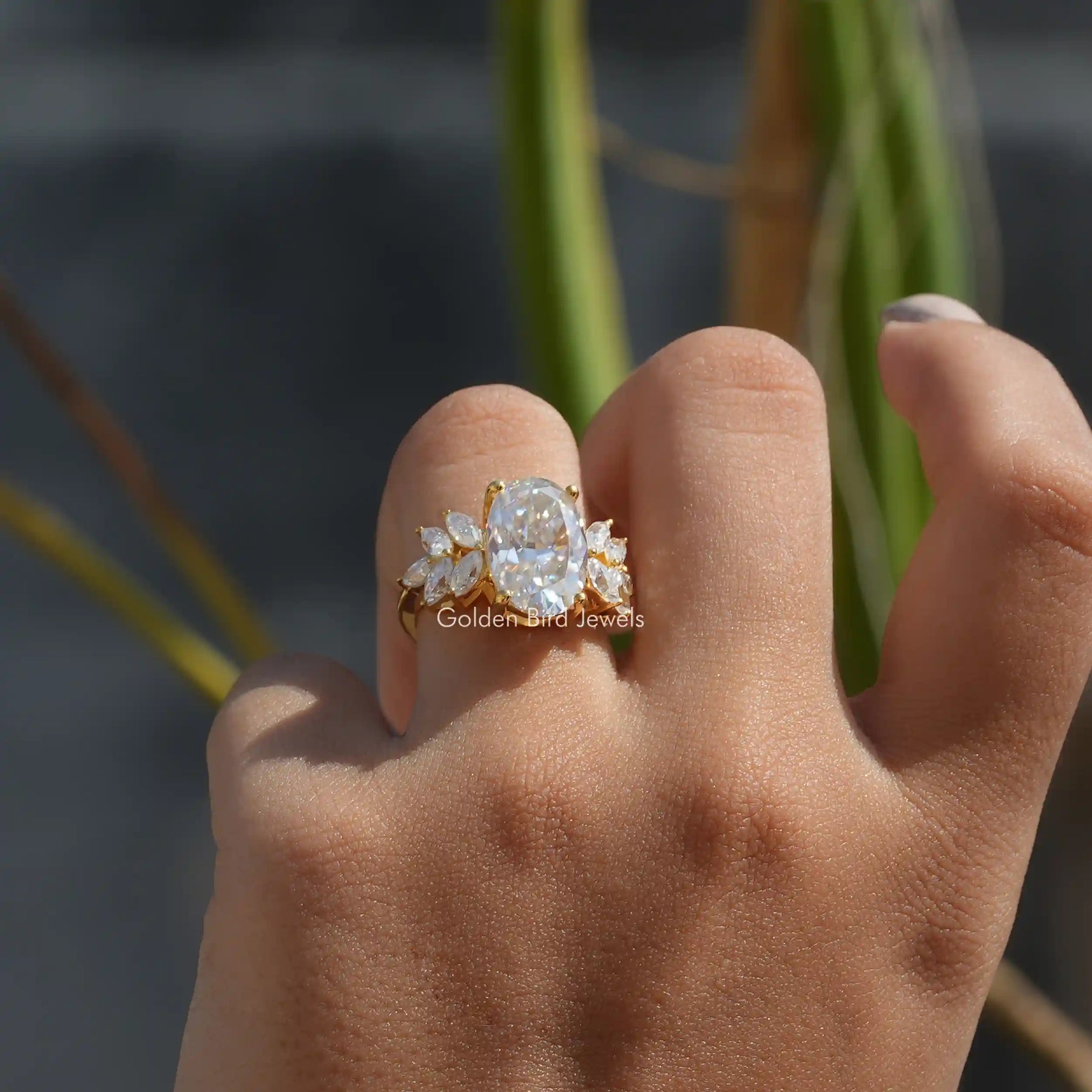 View of Moissanite Oval Cut Cluster Engagement Ring In Finger