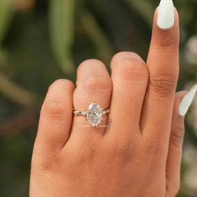 View of Oval Cut Accent Stone Engagement Ring In Finger
