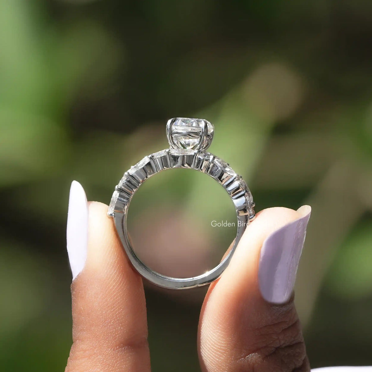 Back View of Moissanite Oval Cut Bridal Ring Set In two fingers