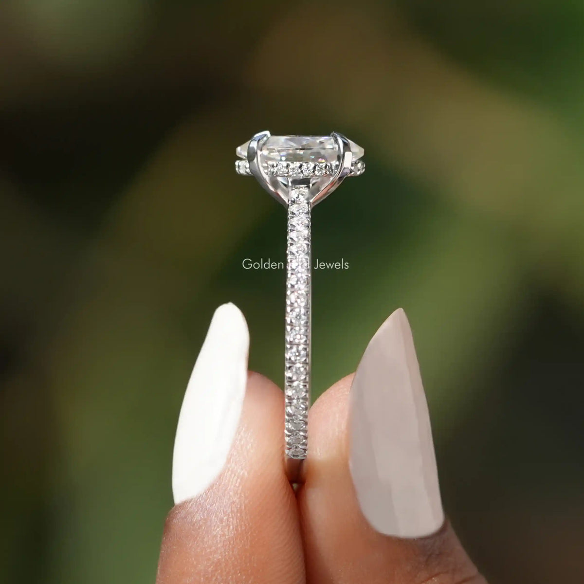 Side View of Oval Cut Hidden Halo Moissanite Ring In two fingers