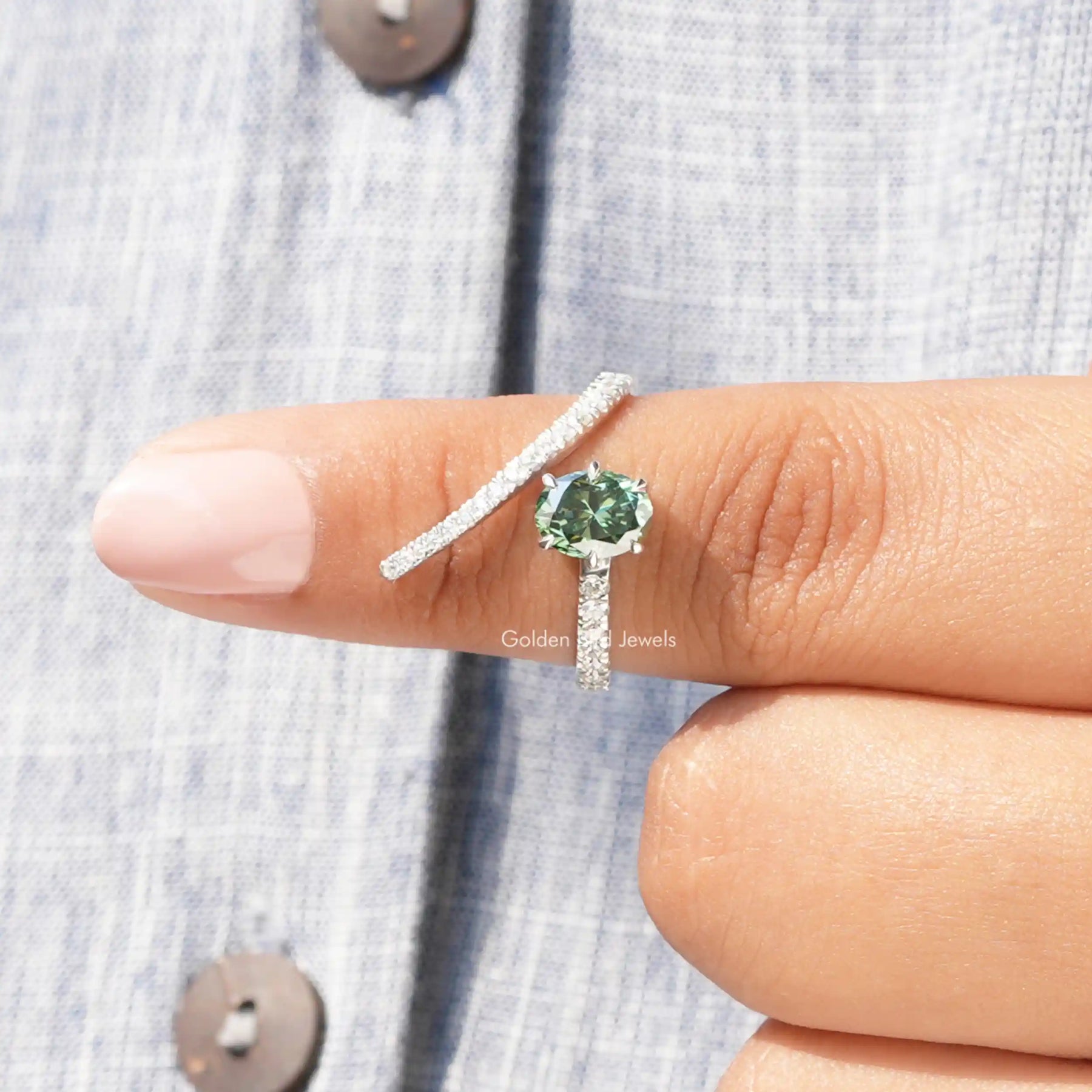 In finger front View of Green Oval Cut Moissanite Engagement Ring In White Gold