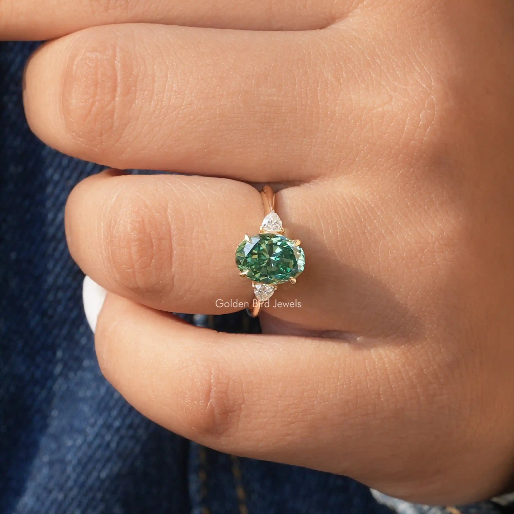 Detailed View Of Three Stone Oval Cut Engagement Ring In Yellow Gold