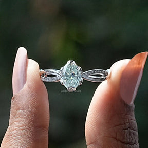 Two fingers holding the Oval Cut Moissanite Shank Engagement Ring