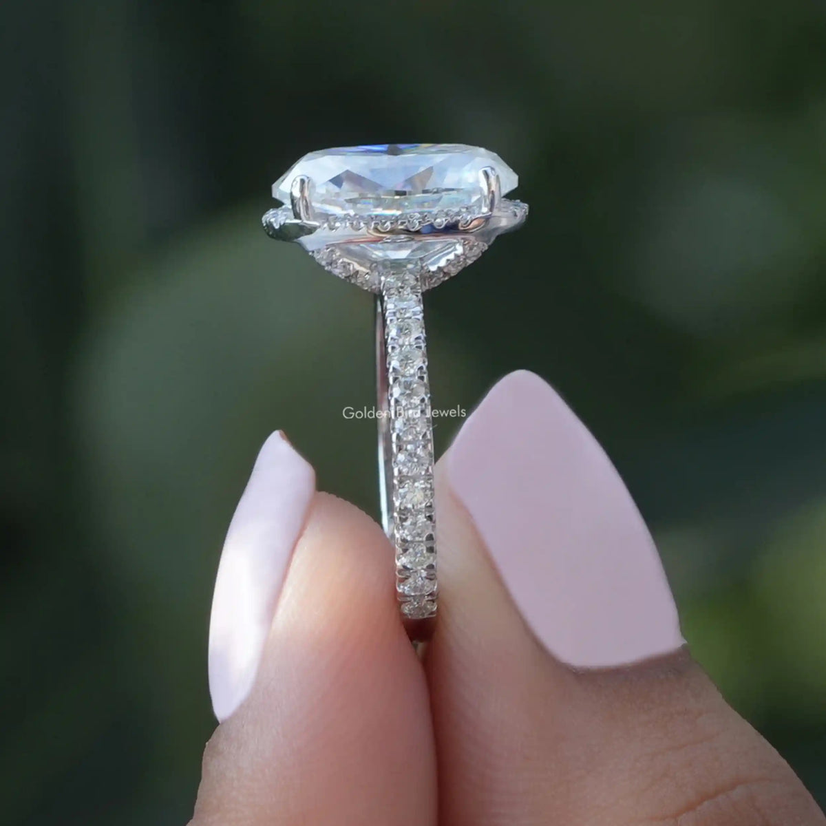 Side View of Oval Cut Moissanite Engagement Ring In two fingers