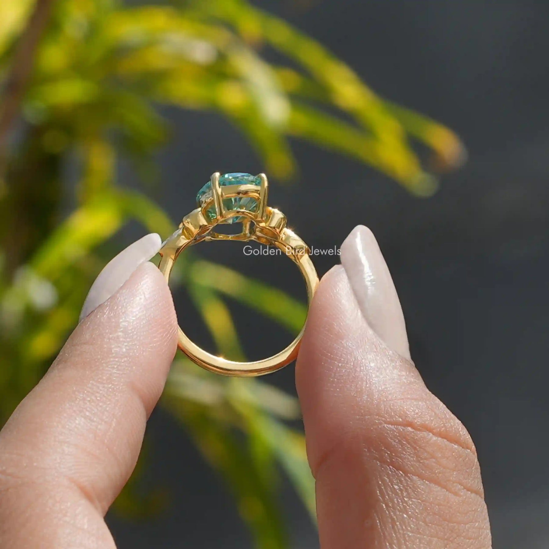 Back View of Oval And Marquise Moissanite Ring In two fingers