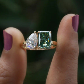 Front View of Pear And Radiant Cut Moissanite Toi Et Moi Ring In two Fingers