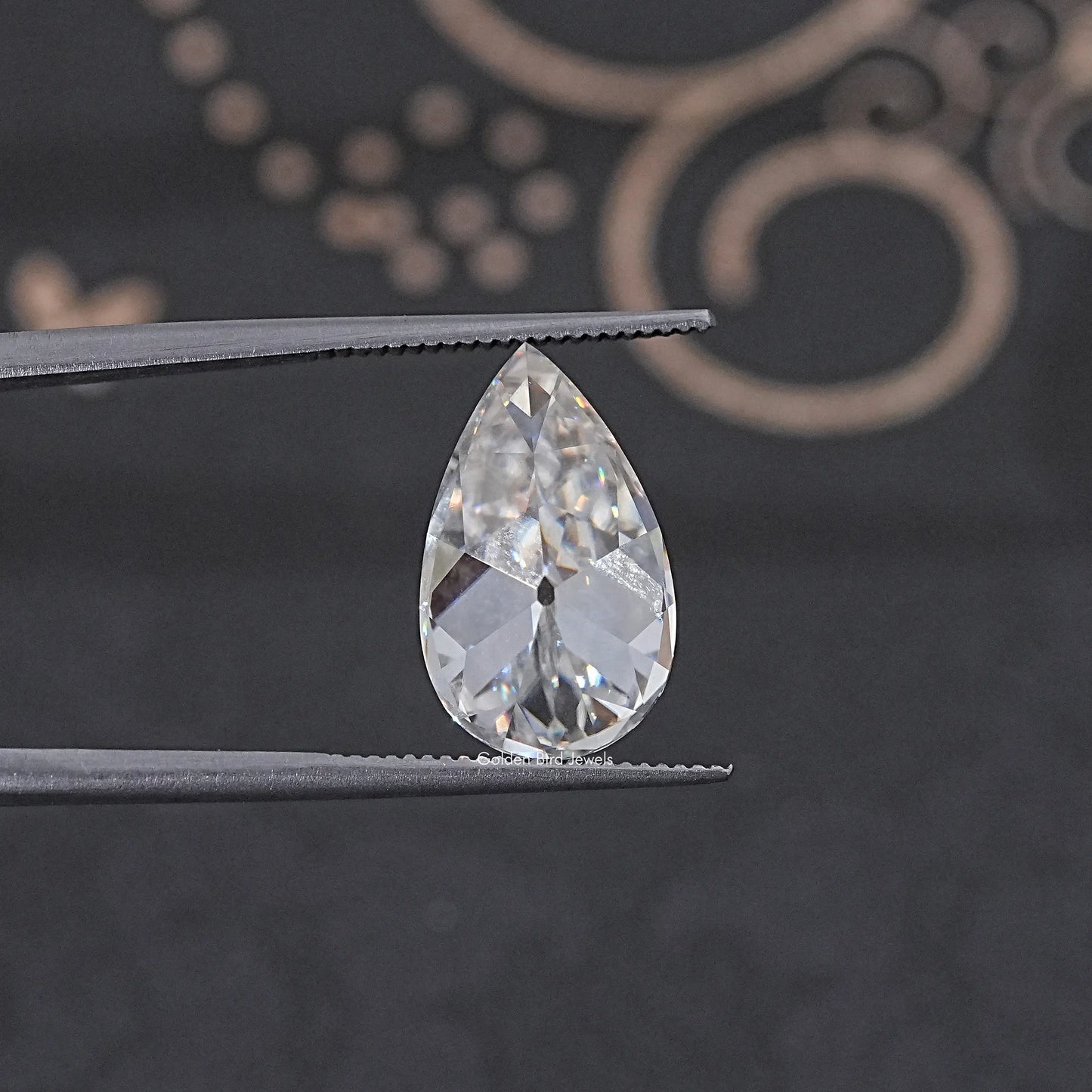 In Tweezer View Of Old Mine Pear Cut Loose Moissanite Stone