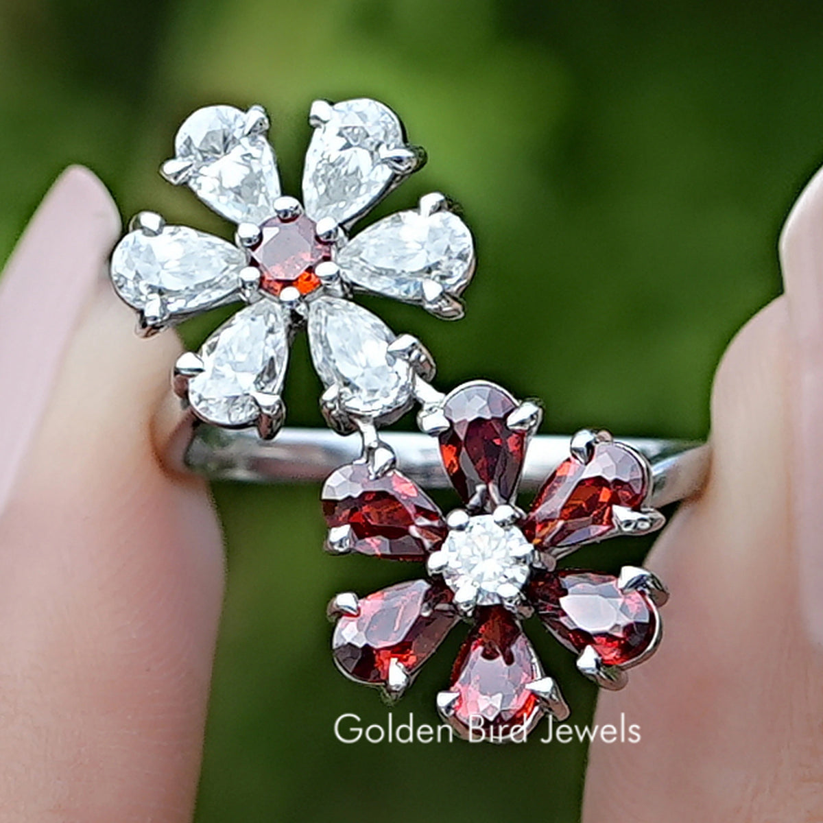 Front view of Pear Gemstone Flower Shape Cluster Bypass Ring in two fingers 