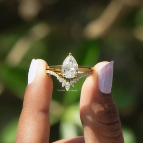 Two fingers holding the Pear Cut Moissanite Bridal Ring