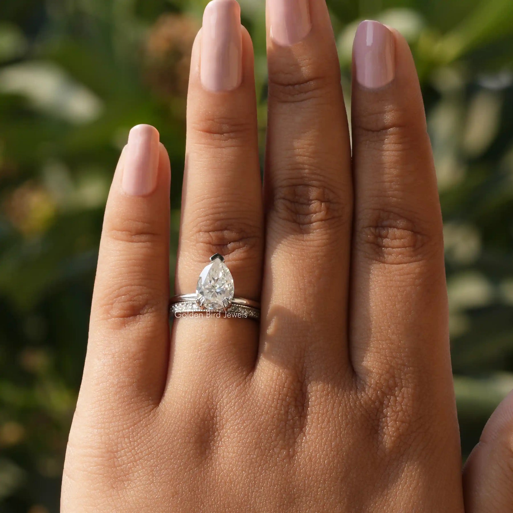 View of Hidden Halo Pear Shaped Moissanite Ring In finger