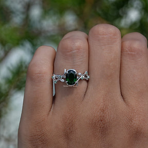 Close-Up View of Green Oval Cut Gemstone Engagement Ring In White Gold