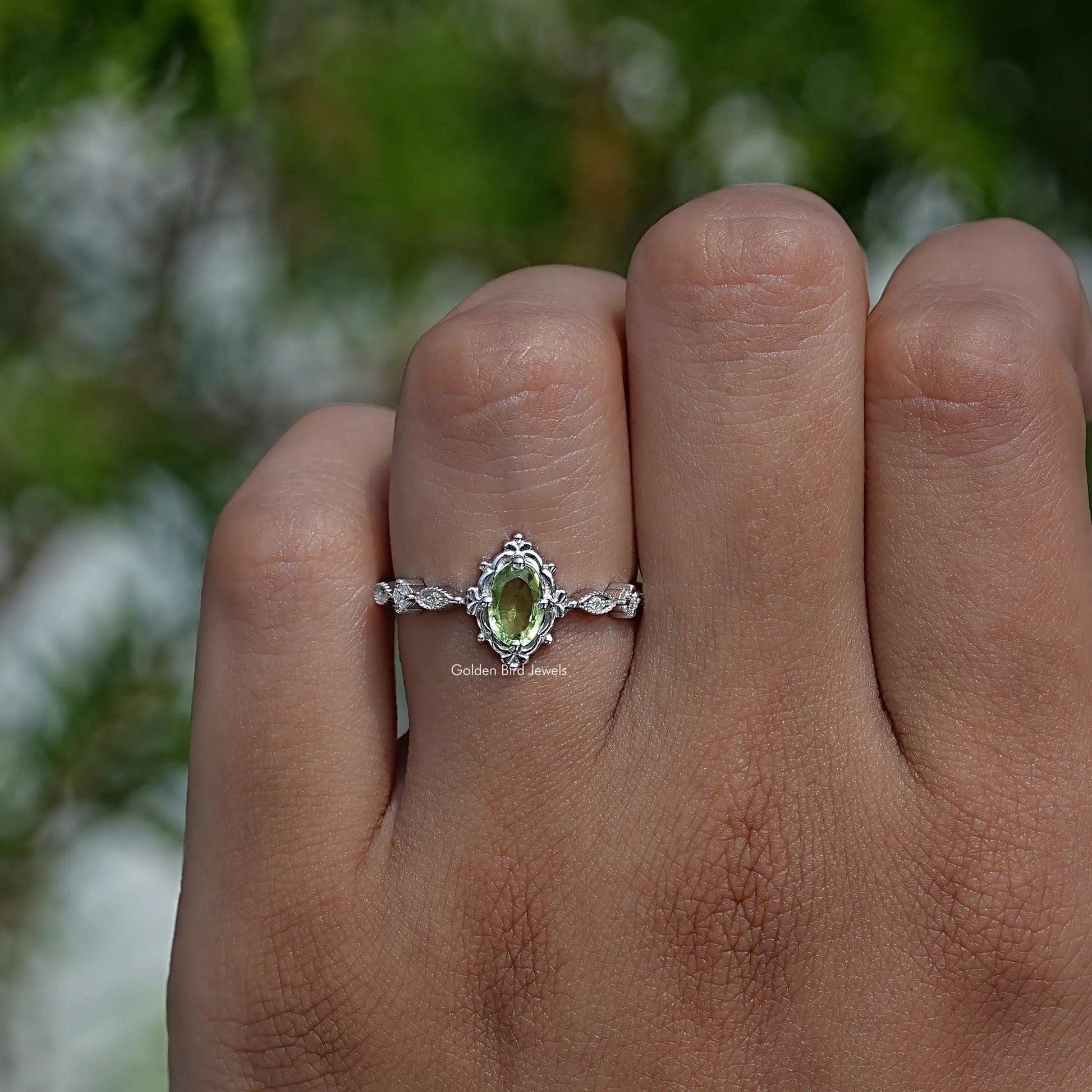 Profile View of Green Oval And Colorless Round Cut Accent Ring
