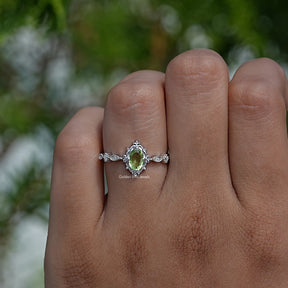 Profile View of Green Oval And Colorless Round Cut Accent Ring