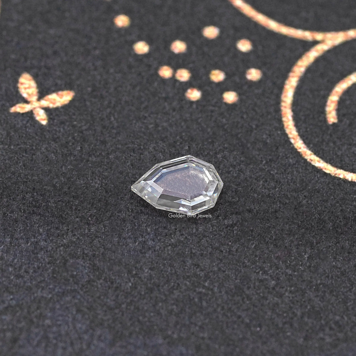 Faceted clear step-cut moissanite loose gemstone on dark fabric background.