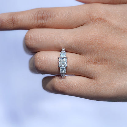 In finger View of Princess And Tapered Baguette Cut Five Stone Ring In White Gold