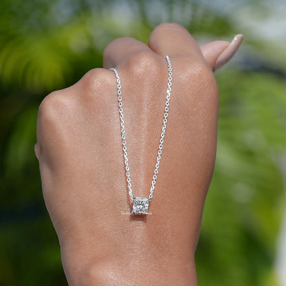 In hand showing view of diamond pendant
