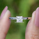 Front view of Princess Cut moissanite engagement ring holding in two fingers 