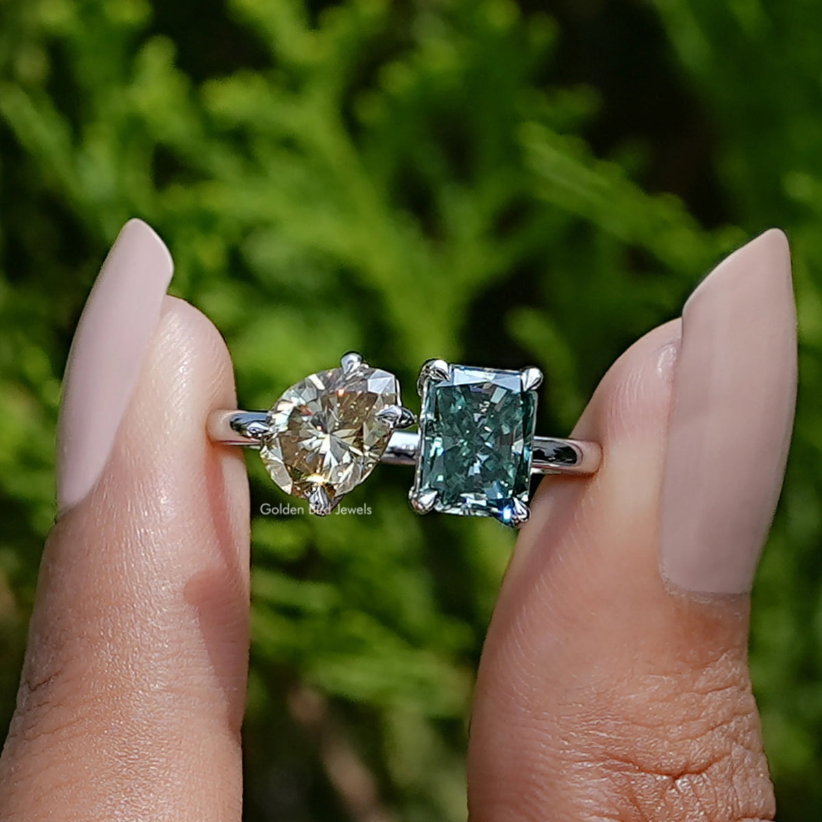 Front View of Radiant And Pear Cut Toi Et Moi Moissanite Ring In two Fingers