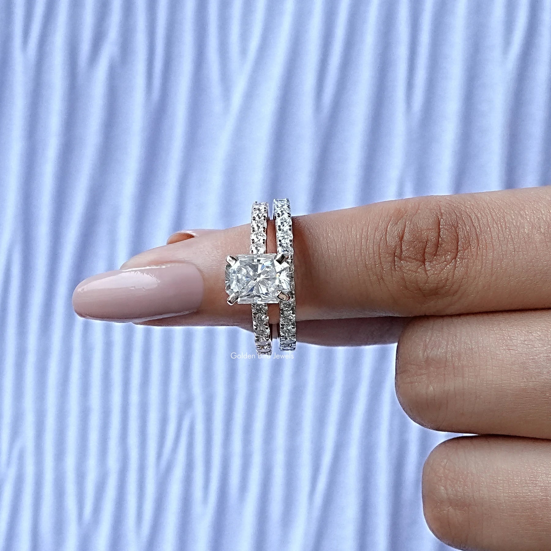 In finger front View of Round And Radiant Cut Hidden Halo Ring Set