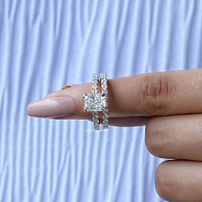 In finger front View of Round And Radiant Cut Hidden Halo Ring Set