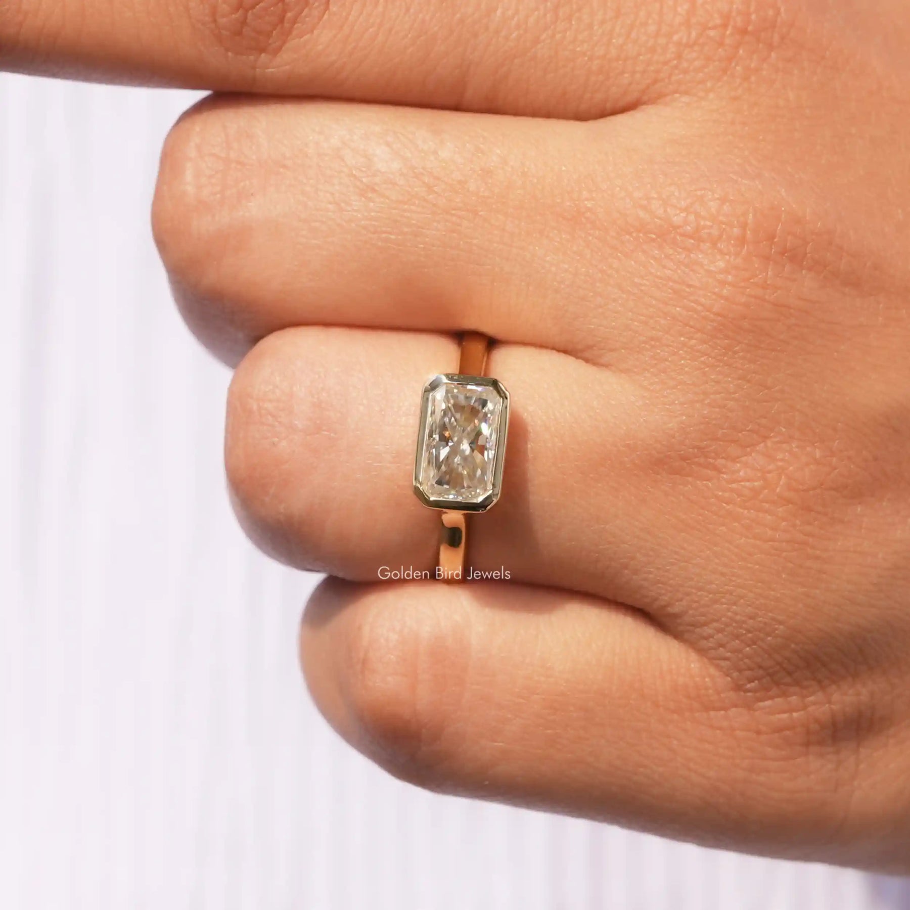 View of Bezel Set Radiant Cut Moissanite Ring In Yellow Gold