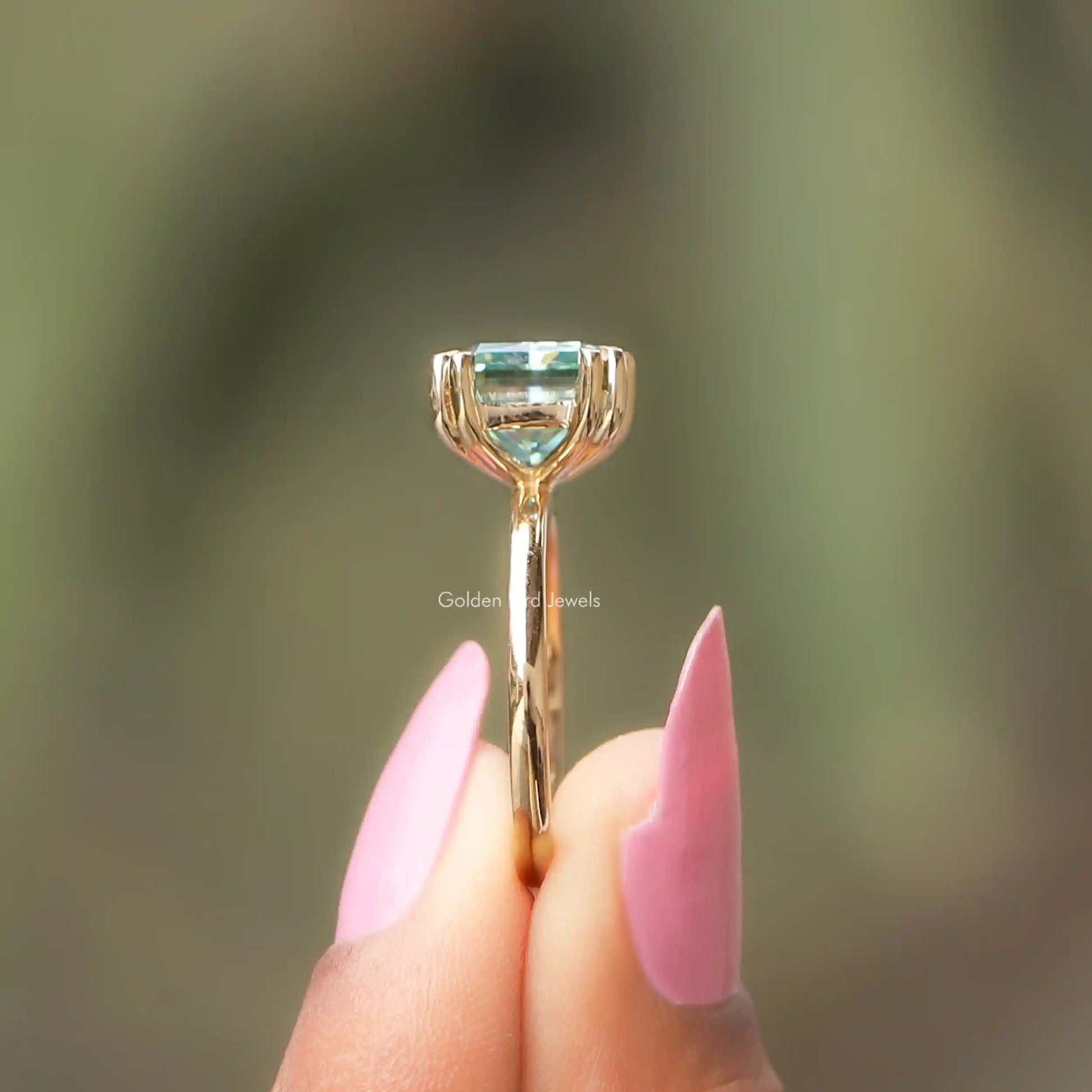 Side View of Radiant Cut Moissanite Ring In two fingers