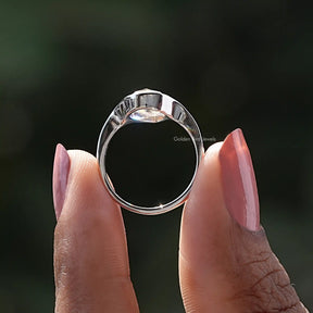 Back View of Pear Cut Moissanite Engagement Ring In two fingers