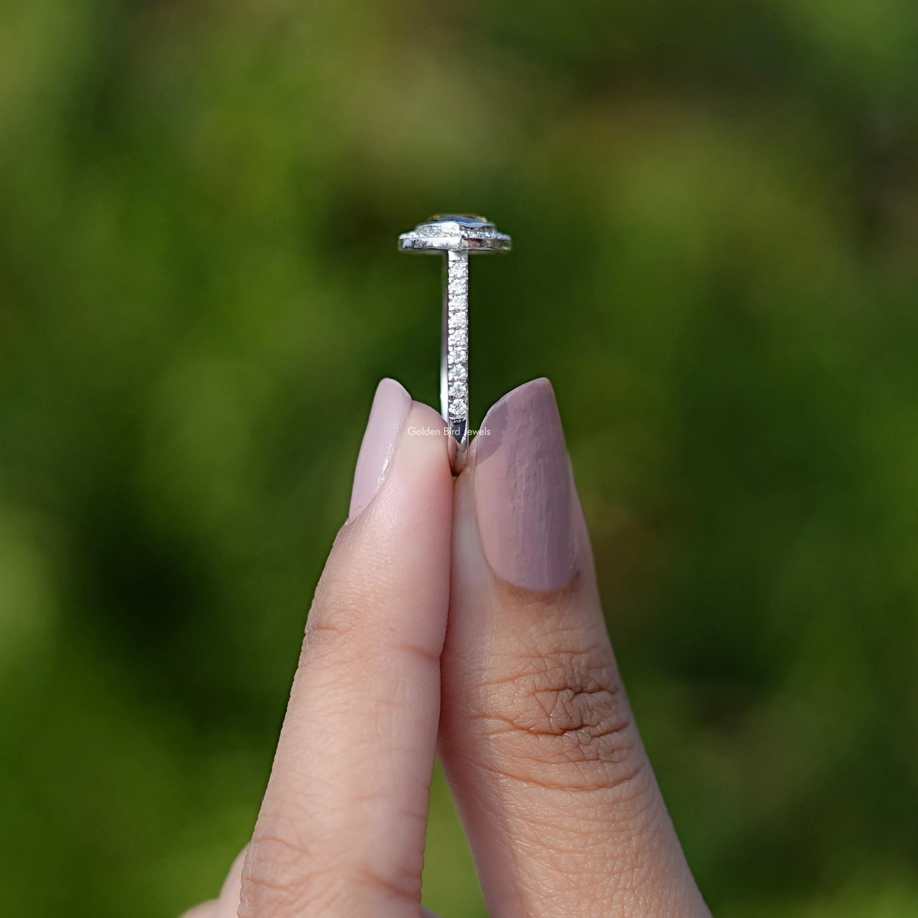 Side View of Rose Cut Pear Moissanite Ring In two fingers