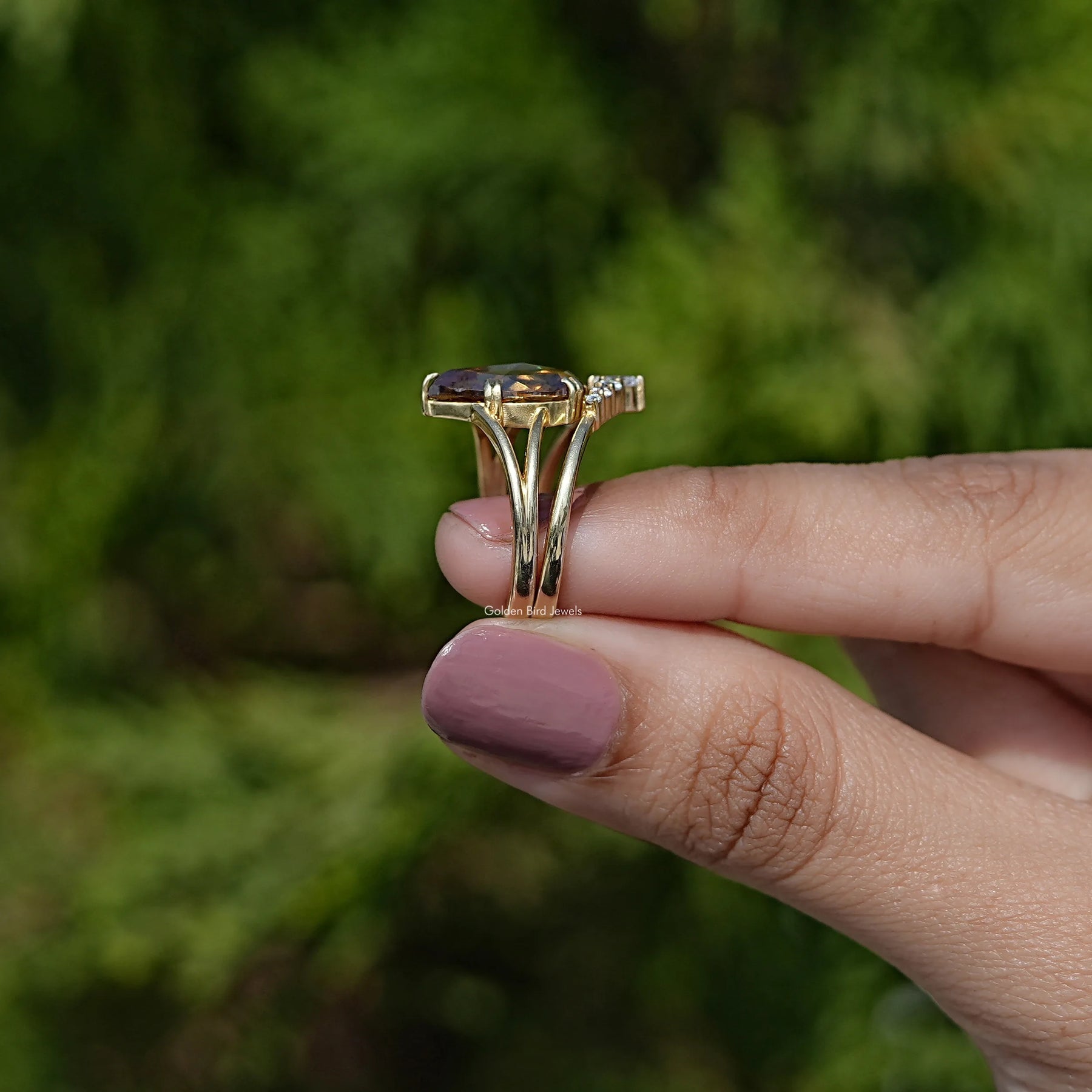 Side View of Pear Cut Moissanite Vintage Curved Ring In two fingers
