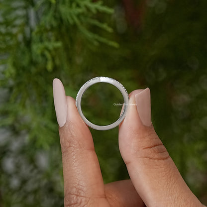 Silver wedding band ring shows inner curve, V-shaped chevron stone top