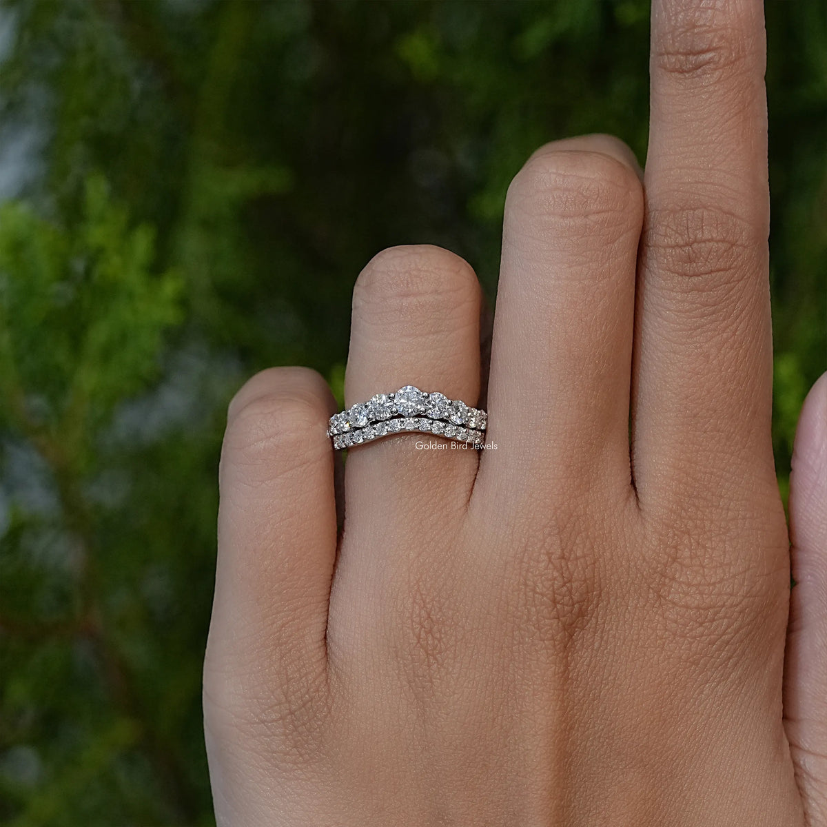Curved double-row eternity band ring with sparkling round stones, side view on hand