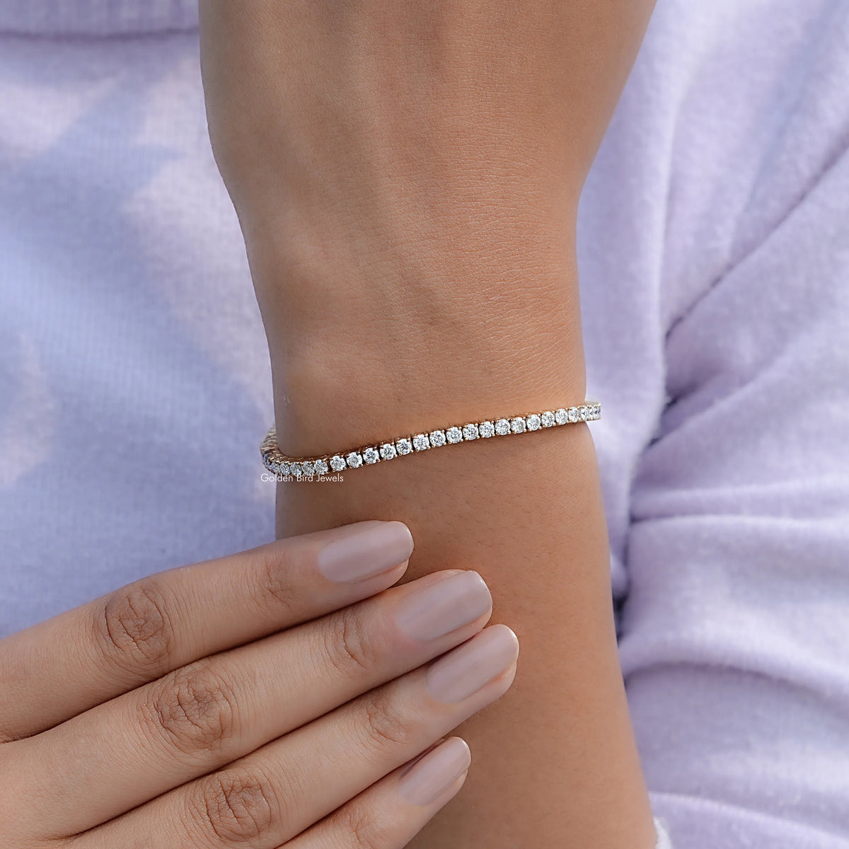 Silver-tone tennis bracelet with round-cut stones on wrist
