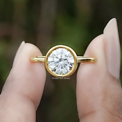 Round Cut Lab Diamond Bezel Set Ring Between Two Fingers